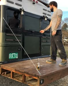 a man standing on top of a wooden platform