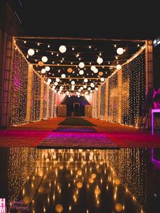 an outdoor wedding venue decorated with lights and decorations