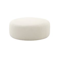 a white round ottoman sitting on top of a floor