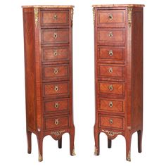 a pair of tall wooden drawers sitting next to each other