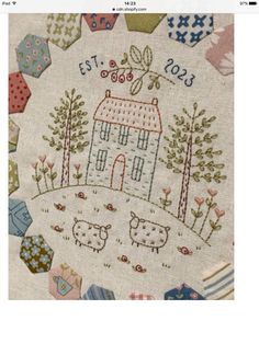 a cross stitch pattern with sheep and houses