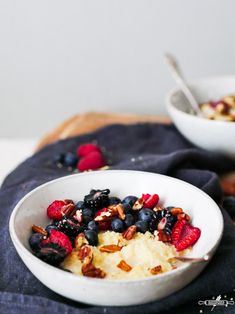 a bowl filled with fruit and nuts on top of a table