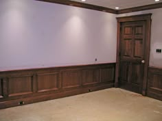 an empty room with wood paneling on the walls, and no one in it