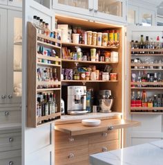 a kitchen pantry with lots of food and drinks in it's cupboards on the wall