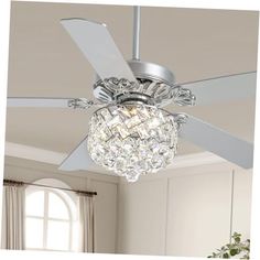 a ceiling fan with crystal balls hanging from it's blades