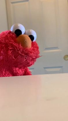 a close up of a stuffed animal on a table