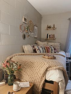 a bedroom with a bed, dresser and coffee cup on the table in front of it