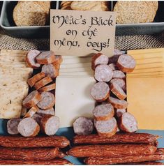 an assortment of meats and cheeses on display