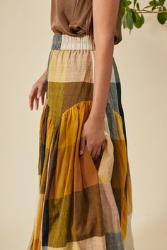 High waisted gathered, maxi skirt with scalloped, gathered drop waist and wide elastic waist band. This skirt has beautiful movement with it's full sweep. Model 5'8 | Size S 100% Hand Loomed Cotton Designed In New York | Handcrafted In India This garment is comfortable fit with an elastic waist. Questions about the fit? email us at help@rujutasheth.com Click here for sizes corresponding to body measurements *ALL MEASUREMENTS BELOW ARE GARMENT MEASURED ON THE FLAT * SIZE WAIST HIPS LENGTH XS 28”- Rujuta Sheth, Woven Wrap, Hand Loom, Outerwear Sweater, Drop Waist, Hip Length, Body Measurements, Long Skirt, Jumpsuit Dress