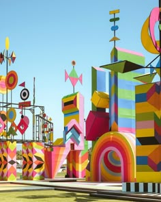 colorful sculptures on display in an open field