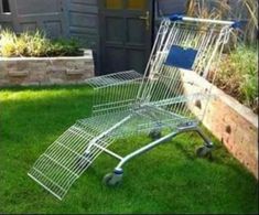 an empty shopping cart sitting in the grass