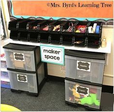 some plastic bins with labels on them in front of a shelf filled with crafting supplies