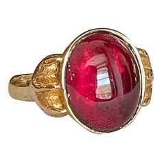 Step back to a time of refined elegance with this Victorian Garnet Signet Ring, a splendid piece that exudes the charm of the early 19th century. This impressive ring features a large cabochon garnet, measuring 14.4x11.5 mm, set in a distinctive signet style. The garnet is closed backed, emphasizing its rich, deep color and classic appeal.  Originally crafted around 1840-50, the ring has been expertly re-shanked; while the top mounting and the intricately detailed clawed feet are made of 15 karat gold, the band itself has been updated with 9 karat gold. Measuring 15.3 mm north to south and 19.3 mm across at the face, the ring sits 6 mm off the finger and narrows to 2.5 mm at the back. Weighing 4.8 grams and sized at 10, this well-loved ring showcases both historical craftsmanship and a tim Luxury Ruby Ring With Cabochon Cut, Vintage Garnet Jewelry, Luxury Ruby Ring With Oval Cabochon, Luxury Ruby Ring Oval Cabochon Polished Finish, Luxury Ruby Oval Cabochon Ring, Elegant Gold Garnet Cabochon Jewelry, Luxury Ruby Ring Oval Cabochon, Luxury Ruby Ring Oval Cabochon With Polished Finish, Luxury Ruby Ring With Oval Cabochon And Polished Finish