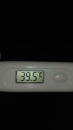 a digital thermometer in front of a black background