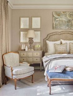 a bed room with a neatly made bed and two chairs next to each other in front of pictures on the wall