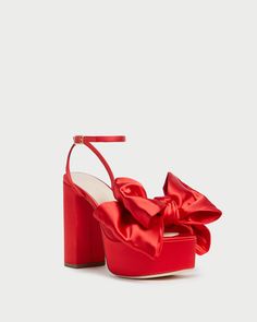 Platform sandal in red satin topped with a statement-making oversized bow. Features a leather footbed with a gold stamped logo, an open toe, and an adjustable buckle ankle strap. 4.75-inch heel, 2-inch platform.  Platform sandal in red satin topped with a statement-making oversized bow. Features a leather footbed with a gold stamped logo, an open toe, and an adjustable buckle ankle strap. 4.75-inch heel, 2-inch platform. Red Satin Top, Red Platform, Steve Madden Heels, Bow Heels, Sneaker Dress Shoes, Red High, Platform Sandals Heels, Loeffler Randall, Satin Bow