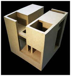 an unfinished cardboard model of a house