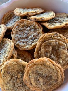 a white bowl filled with cookies on top of a table