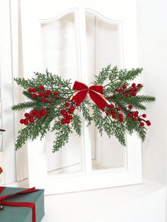 a christmas decoration with holly and red berries