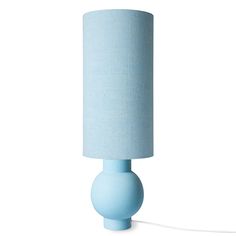 a light blue table lamp with a white shade on the base and a cord attached to it