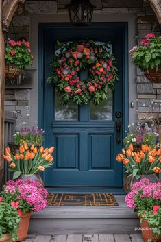 a blue front door with flowers and wreaths on it