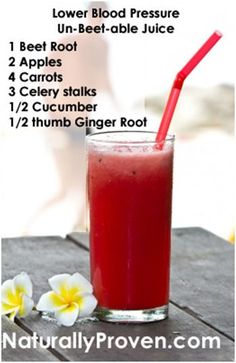 a red drink sitting on top of a wooden table