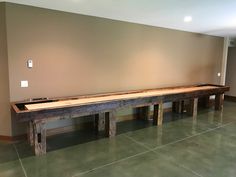 a long wooden bench sitting in the middle of a room