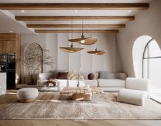 a living room filled with white furniture and lots of wooden beams on the ceiling above