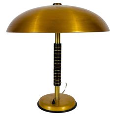 a gold colored lamp with a black base