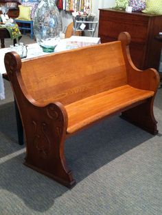 a wooden bench sitting on top of a carpeted floor