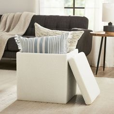 a living room filled with furniture and pillows