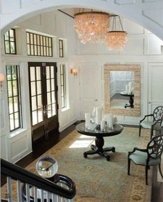 a living room filled with furniture and a chandelier