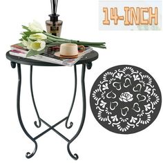 an iron table with flowers and candles on it