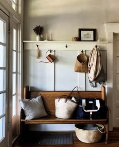 a wooden bench sitting in front of a window filled with purses and handbags