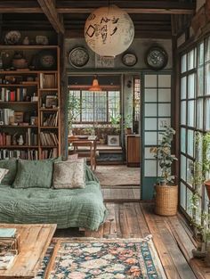 a living room filled with lots of furniture and bookshelves next to a window