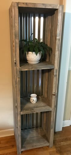 a wooden shelf with some plants in it