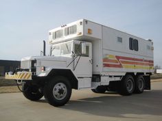 a large white truck parked on top of a parking lot