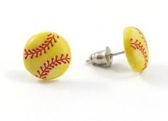 baseball ball stud earrings in yellow with red stitching on the outside and white background