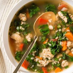 a close up of a bowl of soup with meat and veggies on the side