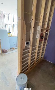 the inside of a building being remodeled with wood framing and insulation tape on the walls