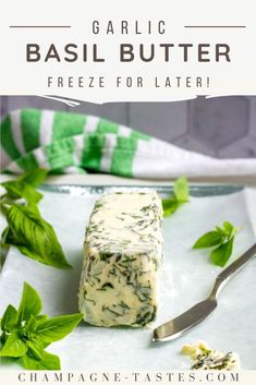 garlic basil butter freeze for later on a plate with a knife and spoon next to it