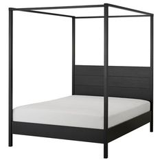 a bed with a black frame and white sheets on it's headboard, in front of a white background