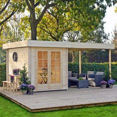 an outdoor living area in the middle of a yard