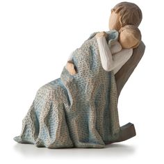 a figurine of a woman holding a baby