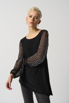 This luxurious tunic is crafted from a silky knit fabric, with mesh puff sleeves for a touch of drama. The asymmetrical design is flattering and feminine, while the beading detail adds a touch of glamour.  Color - Black. Silky knit with mesh. Beading on sleeves. Boat neckline. Puff sleeves. Asymmetrical hem. Unlined. Sheer Sleeves Top, Stylish Tunic, Feminine Blouses, Black Tunic, Joseph Ribkoff, Beaded Top, Knit Tunic, Asymmetrical Design, Tunic Styles