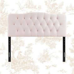 an upholstered headboard is shown against a floral wallpaper