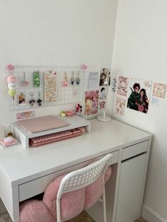 a white desk topped with a pink chair next to a desktop computer and pictures on the wall