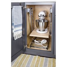 an open cabinet with a mixer and other kitchen accessories