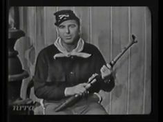 an old black and white photo of a man holding a baseball bat