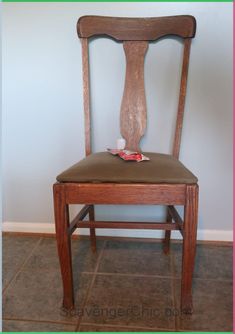 a wooden chair with a piece of paper on the back of it's seat